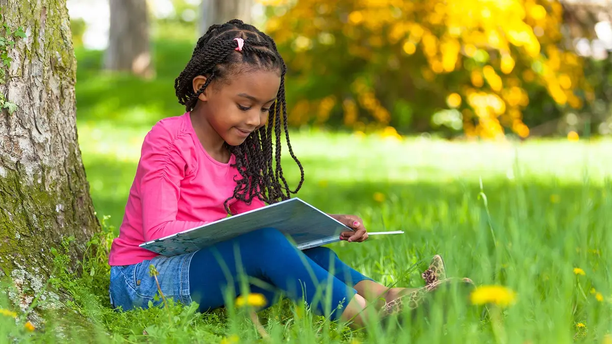 A child reading in the sunlight